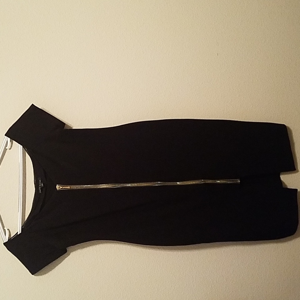 Black curve hugging dress .